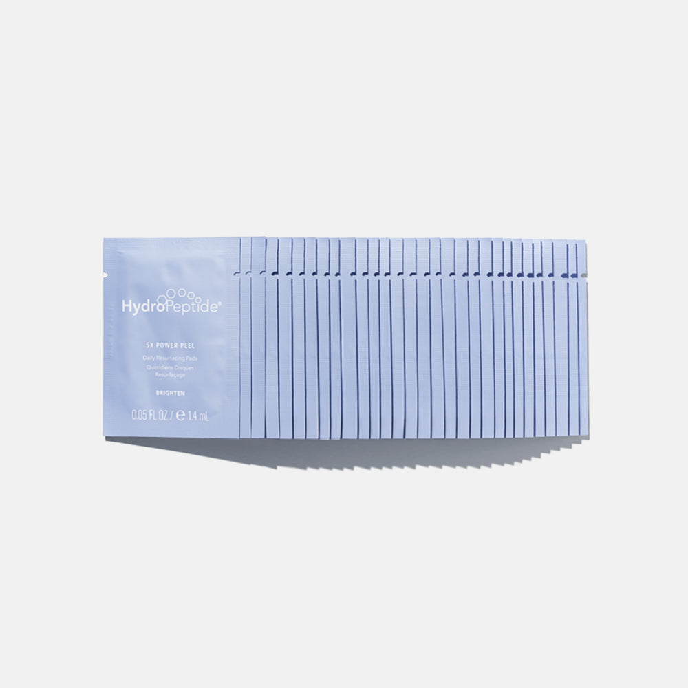 Stack of blue Hydropeptide face masks on a light gray background